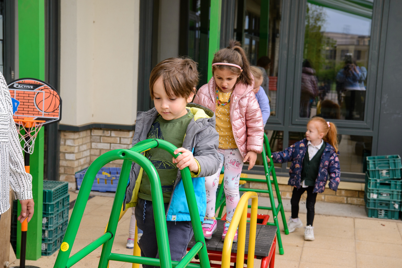 Nursery children outside the classroom using playground climbing equipment